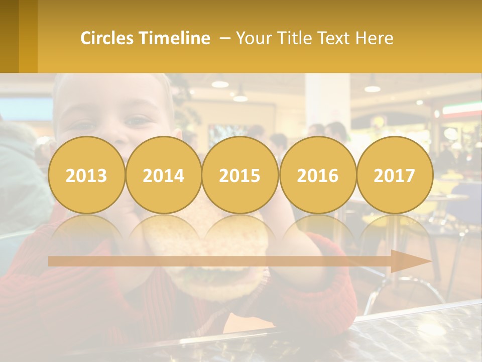 A Young Boy Eating A Sandwich In A Restaurant PowerPoint Template