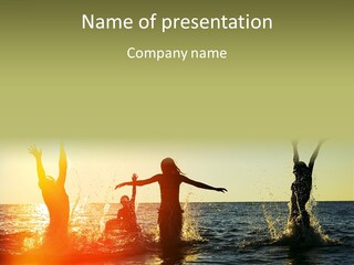 A Group Of People Playing In The Water At Sunset PowerPoint Template