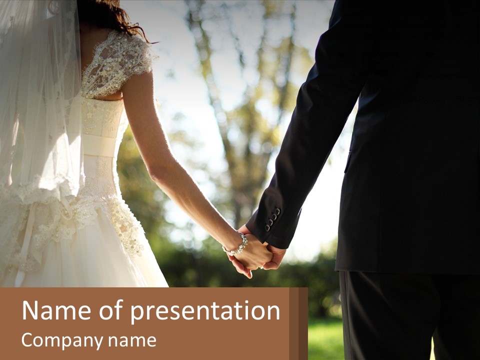 A Bride And Groom Holding Hands In A Park PowerPoint Template