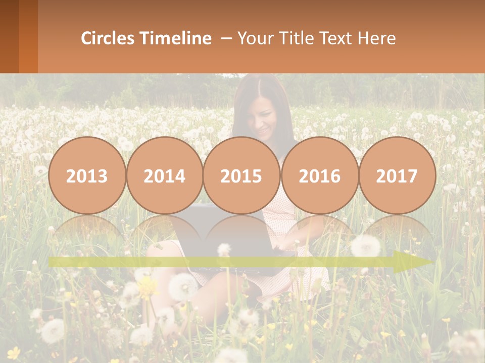 A Woman Sitting In A Field With A Laptop PowerPoint Template