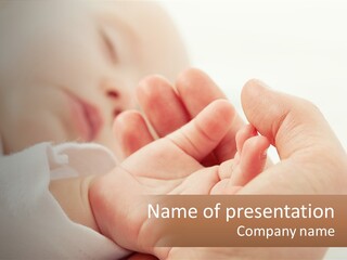 A Person Holding A Baby In Their Hands PowerPoint Template