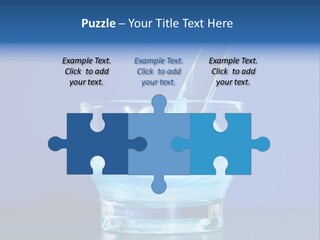 A Glass Of Blue Liquid With A Spoon In It PowerPoint Template