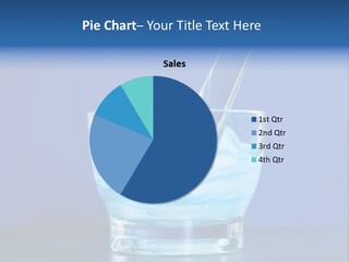 A Glass Of Blue Liquid With A Spoon In It PowerPoint Template