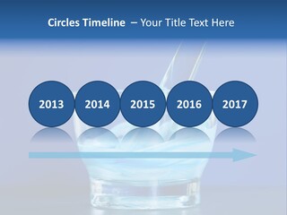 A Glass Of Blue Liquid With A Spoon In It PowerPoint Template