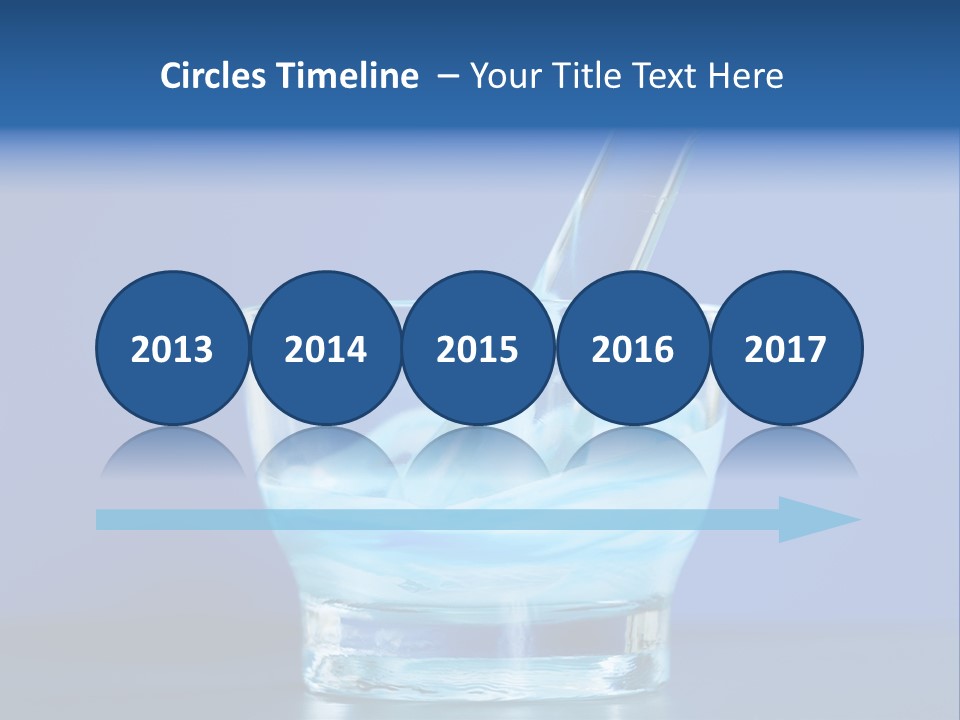 A Glass Of Blue Liquid With A Spoon In It PowerPoint Template