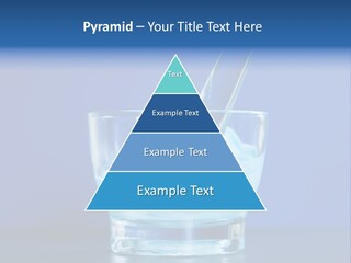 A Glass Of Blue Liquid With A Spoon In It PowerPoint Template