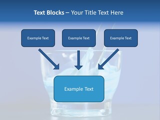 A Glass Of Blue Liquid With A Spoon In It PowerPoint Template