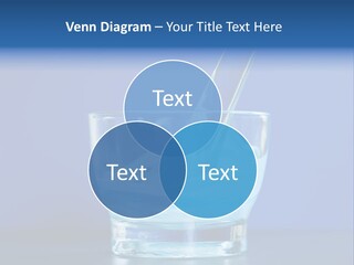 A Glass Of Blue Liquid With A Spoon In It PowerPoint Template