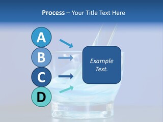 A Glass Of Blue Liquid With A Spoon In It PowerPoint Template