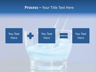 A Glass Of Blue Liquid With A Spoon In It PowerPoint Template