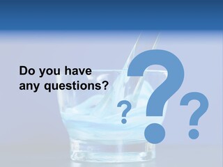 A Glass Of Blue Liquid With A Spoon In It PowerPoint Template