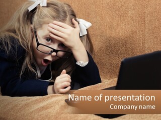 A Little Girl Sitting On A Couch Looking At A Laptop PowerPoint Template