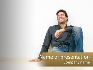 A Man Sitting On The Floor In Front Of A White Wall PowerPoint Template