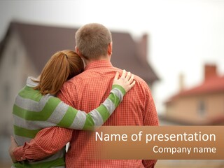 A Man And Woman Embracing In Front Of A House PowerPoint Template