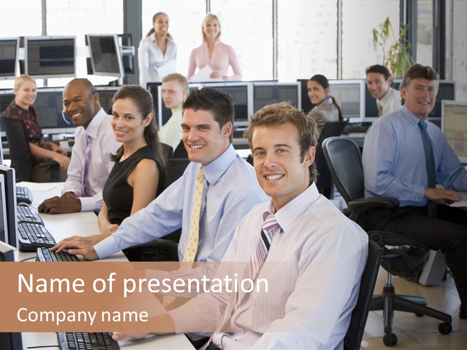 A Group Of People Sitting In Front Of Computers PowerPoint Template