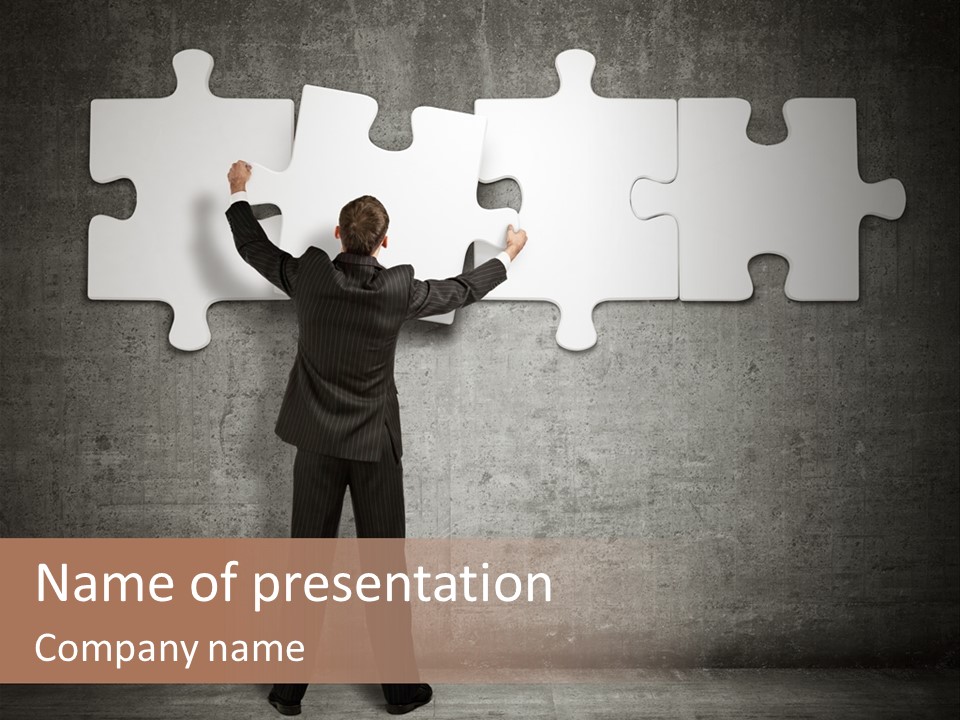 A Man In A Suit Holding A Puzzle Piece PowerPoint Template