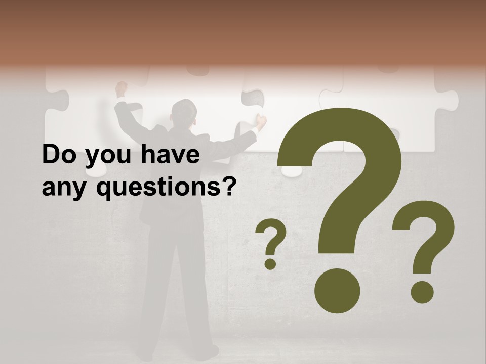 A Man In A Suit Holding A Puzzle Piece PowerPoint Template