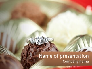 A Group Of Chocolates With A Diamond Ring On Top PowerPoint Template