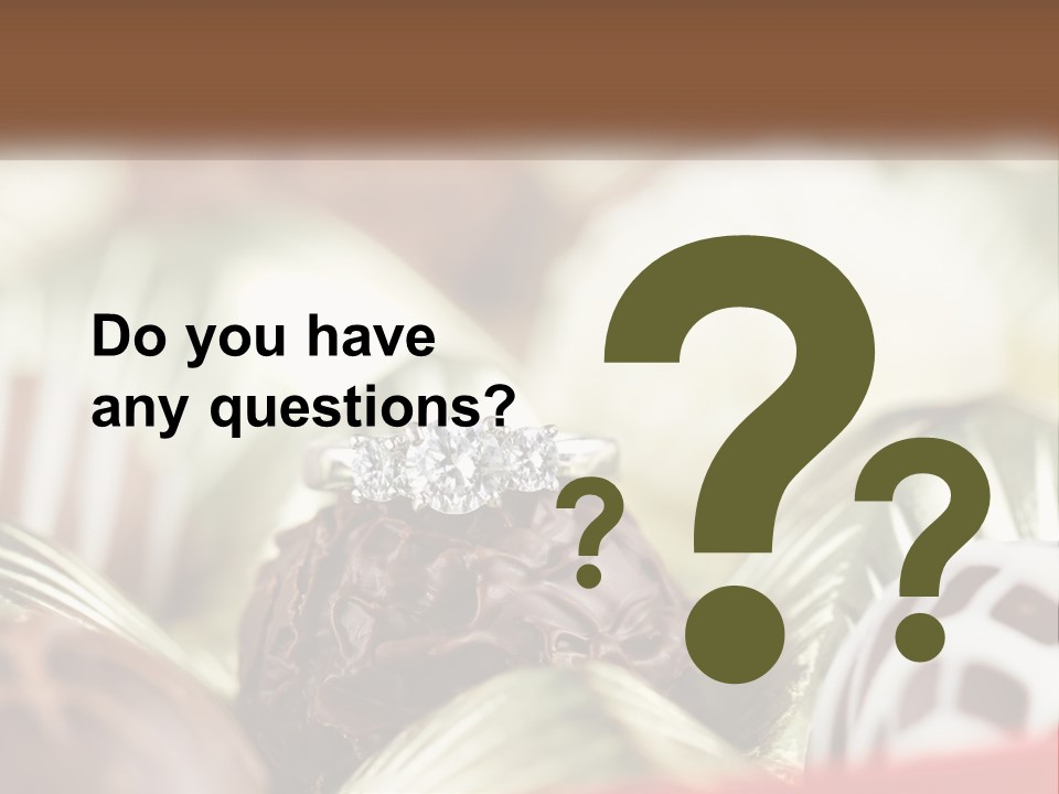 A Group Of Chocolates With A Diamond Ring On Top PowerPoint Template