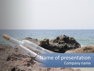 A Message In A Bottle On A Rocky Beach PowerPoint Template