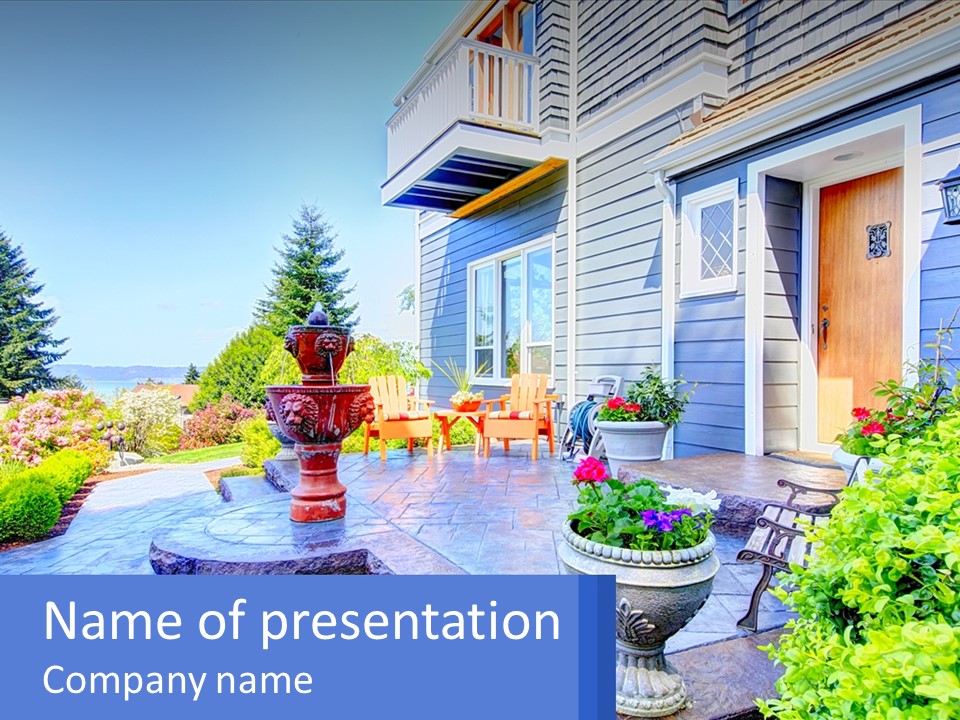 A Blue House With A Fountain In Front Of It PowerPoint Template