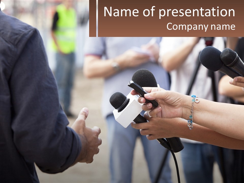 A Person Holding A Microphone In Front Of Microphones PowerPoint Template
