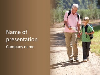 A Man And A Boy Walking Down A Dirt Road PowerPoint Template