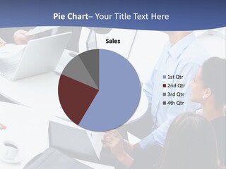 A Group Of People Sitting Around A Table With Laptops PowerPoint Template