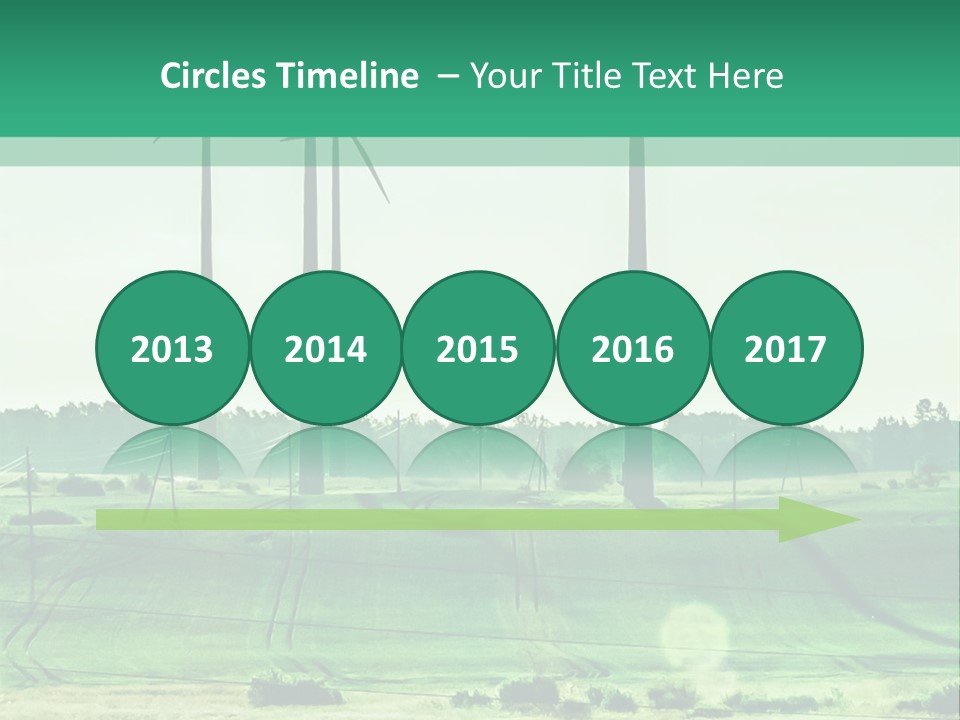 A Green Field With Windmills In The Background PowerPoint Template