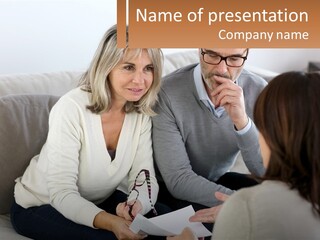 A Man And Woman Sitting On A Couch Talking To Each Other PowerPoint Template