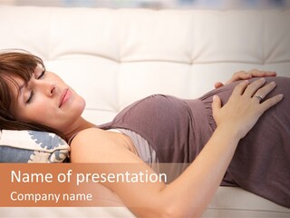 A Pregnant Woman Laying On A White Couch PowerPoint Template