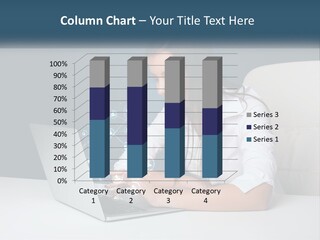 A Woman Sitting At A Desk Using A Laptop Computer PowerPoint Template