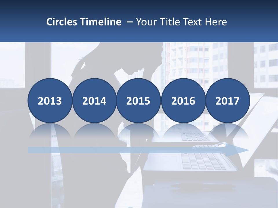 A Man Sitting In Front Of A Laptop Computer PowerPoint Template