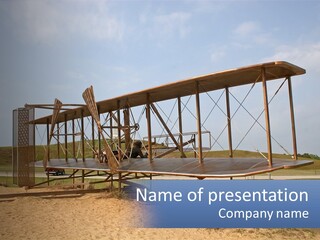 An Old Airplane Sitting On Top Of A Dirt Field PowerPoint Template