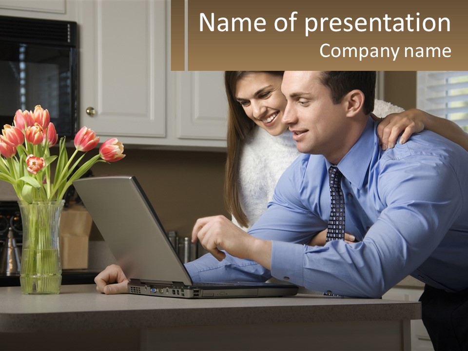 A Man And Woman Looking At A Laptop Computer PowerPoint Template