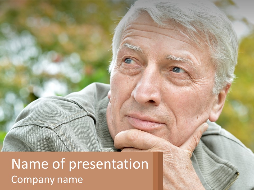 An Elderly Man Is Looking At The Camera With His Hand On His Chin PowerPoint Template