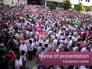 A Large Group Of People Are Walking Down The Street PowerPoint Template