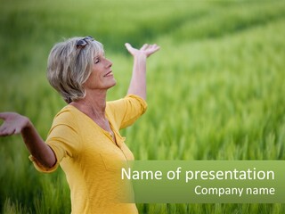 A Woman Standing In A Field Of Green Grass PowerPoint Template