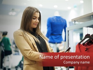 A Woman Looking At A Cell Phone In A Clothing Store PowerPoint Template