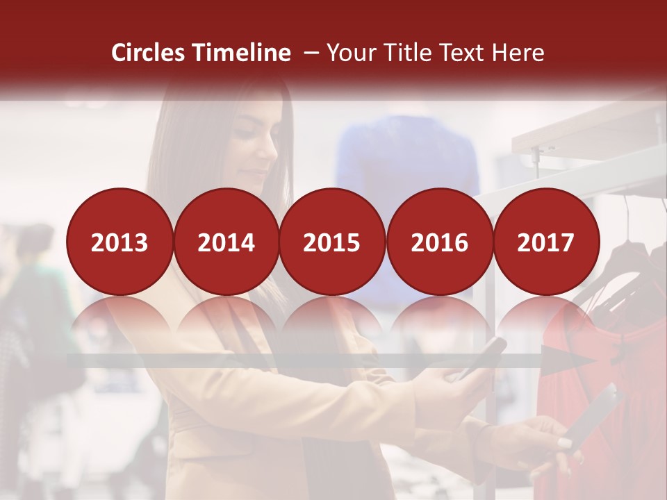 A Woman Looking At A Cell Phone In A Clothing Store PowerPoint Template