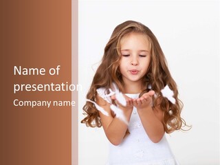 A Little Girl Is Blowing Bubbles In Her Hands PowerPoint Template