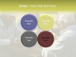 A Group Of Elderly Men Playing Cards At A Picnic Table PowerPoint Template