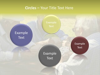 A Group Of Elderly Men Playing Cards At A Picnic Table PowerPoint Template