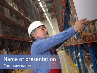 A Man In A Warehouse Is Looking At A Piece Of Paper PowerPoint Template