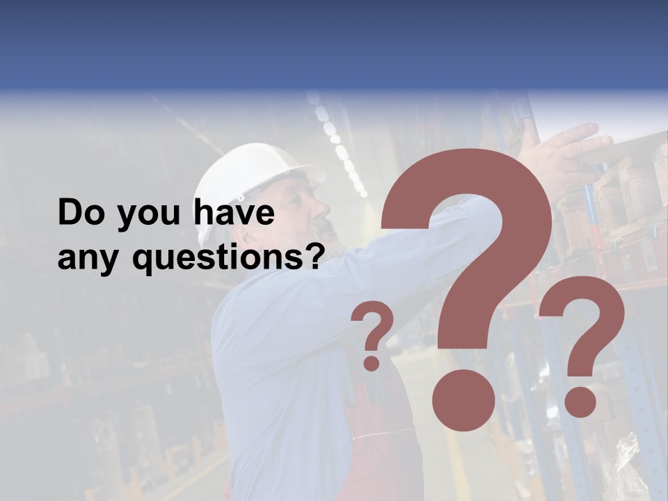 A Man In A Warehouse Is Looking At A Piece Of Paper PowerPoint Template