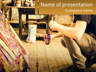 A Man Is Painting A Picture On A Canvas PowerPoint Template