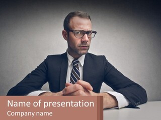 A Man In A Suit And Tie Sitting At A Table PowerPoint Template