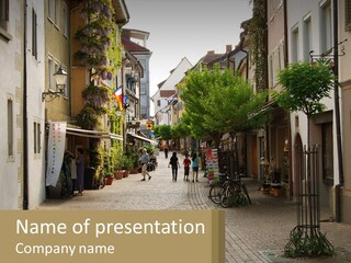 A Group Of People Walking Down A Street Next To Tall Buildings PowerPoint Template