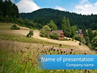 A House In The Middle Of A Field With Trees In The Background PowerPoint Template