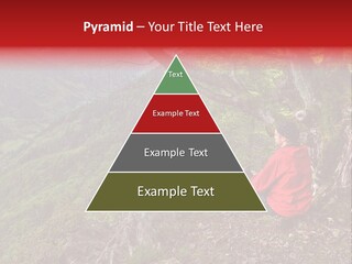 A Man Sitting On Top Of A Mountain Next To A Tree PowerPoint Template